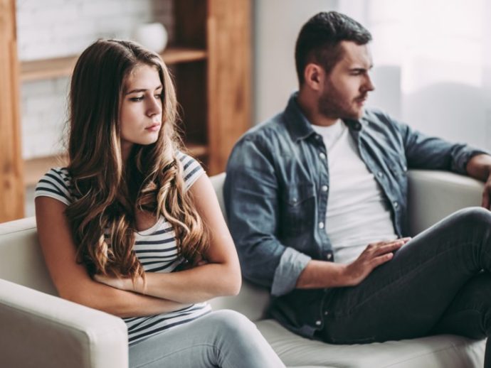 Upset couple sitting on couch