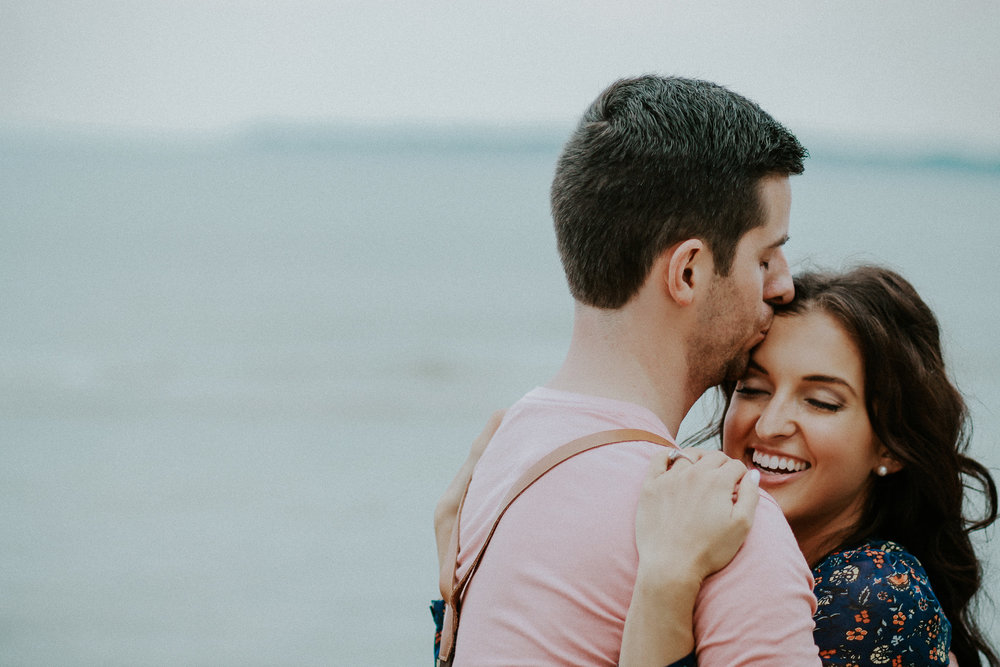 Man kissing woman on forehead